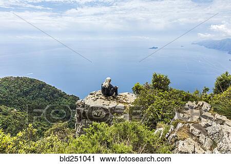 Stock Image - Caucasian woman admiring scenic view of ocean. Fotosearch