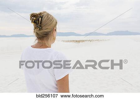 Stock Photo - Caucasian woman admiring scenic view of desert. Fotosearch