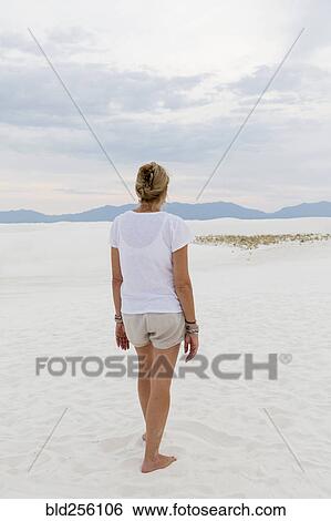Stock Photograph - Caucasian woman admiring scenic view of desert. Fotosearch