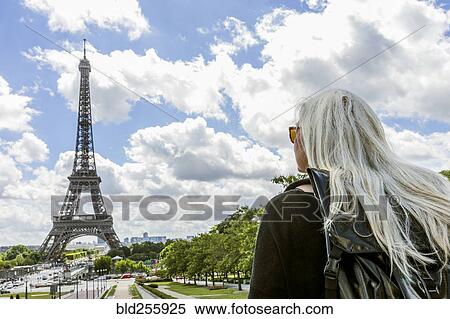 Stock Photography - Caucasian woman admiring scenic view of Eiffel Tower. Fotosearch