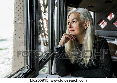 Caucasian woman admiring scenic view from restaurant window View Large Photo Image Stock Photography - Caucasian woman admiring scenic view from restaurant window. Fotosearch
