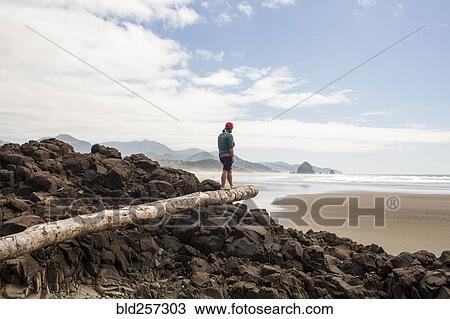 Caucasian woman balancing on log on rocks at beach View Large Photo Image Stock Image - Caucasian woman balancing on log on rocks at beach. Fotosearch