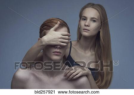 Caucasian woman covering eyes of man View Large Photo Image Stock Image - Caucasian woman covering eyes of man. Fotosearch