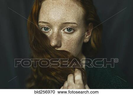 Caucasian woman covering mouth with hair View Large Photo Image Stock Image - Caucasian woman covering mouth with hair. Fotosearch