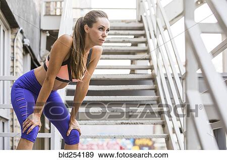 Caucasian woman crouching and resting on urban staircase View Large Photo Image Stock Photo - Caucasian woman crouching and resting on urban staircase. Fotosearch