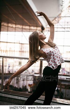 Stock Photography - Caucasian woman dancing near railing. Fotosearch