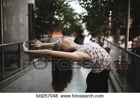 Stock Photo - Caucasian woman dancing outdoors. Fotosearch
