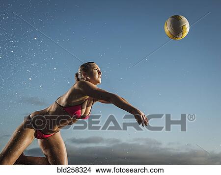 Picture - Caucasian woman diving to volleyball. Fotosearch