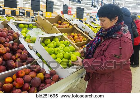 Caucasian woman examining apples View Large Photo Image Stock Photography - Caucasian woman examining apples. Fotosearch