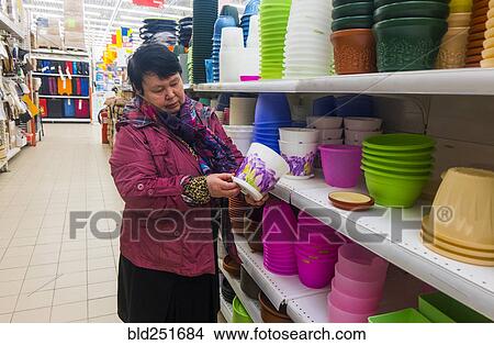 Caucasian woman examining pot in store View Large Photo Image Picture - Caucasian woman examining pot in store. Fotosearch