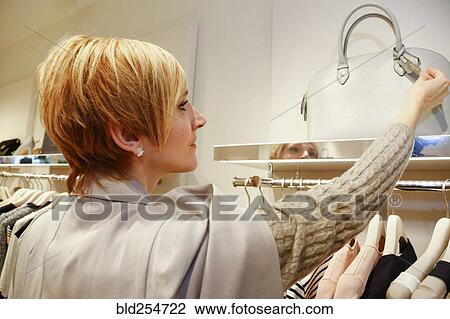Caucasian woman examining purse in store View Large Photo Image Stock Image - Caucasian woman examining purse in store. Fotosearch