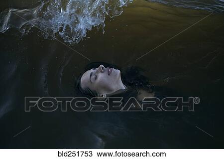 Caucasian woman floating in ocean with eyes closed View Large Photo Image Stock Image - Caucasian woman floating in ocean with eyes closed. Fotosearch