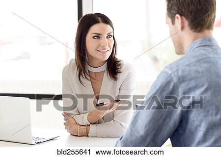 Stock Image - Caucasian woman gesturing to man. Fotosearch