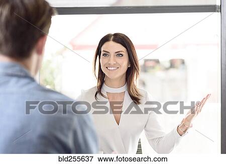 Stock Photo - Caucasian woman gesturing to man. Fotosearch