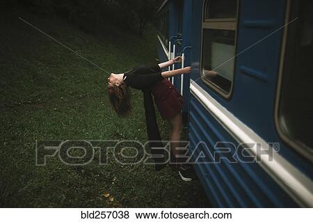 Caucasian woman hanging on train View Large Photo Image Stock Photo - Caucasian woman hanging on train. Fotosearch