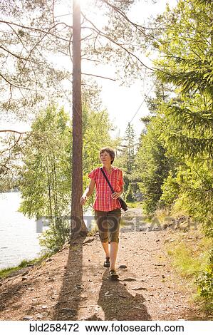 Caucasian woman hiking near river View Large Photo Image Stock Image - Caucasian woman hiking near river. Fotosearch