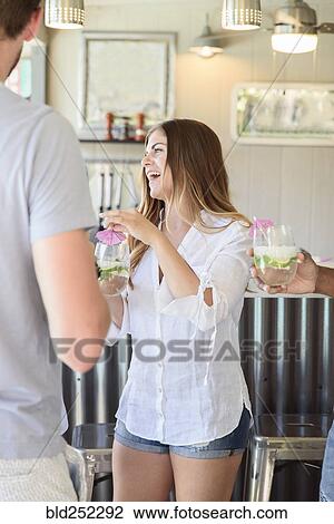 Caucasian woman holding cold drink laughing outdoors View Large Photo Image Stock Image - Caucasian woman holding cold drink laughing outdoors. Fotosearch