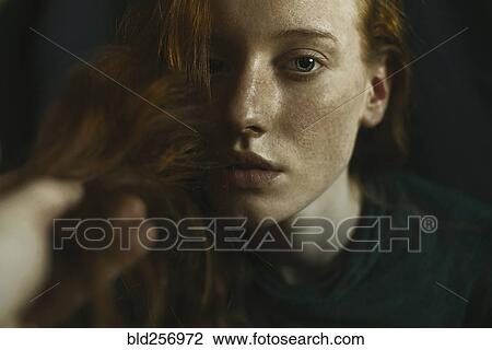 Stock Image - Caucasian woman holding hair. Fotosearch