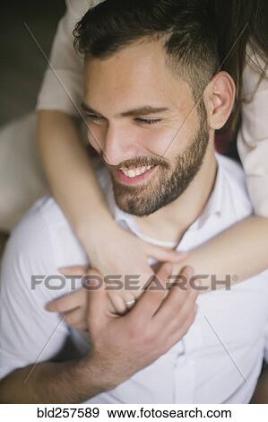 Stock Photo - Caucasian woman hugging smiling man. Fotosearch