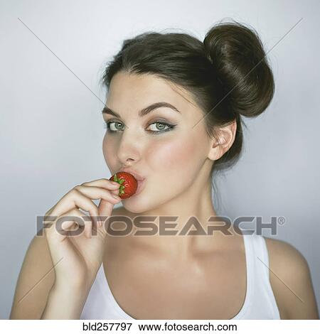 Caucasian woman kissing strawberry View Large Photo Image Stock Photo - Caucasian woman kissing strawberry. Fotosearch