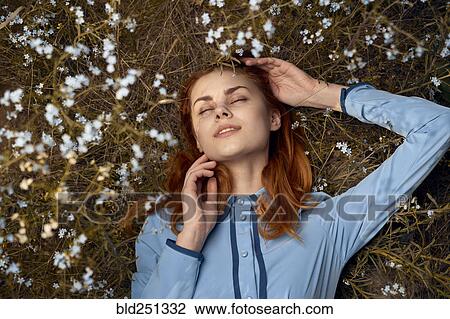 Caucasian woman laying in field of wildflowers View Large Photo Image Stock Image - Caucasian woman laying in field of wildflowers. Fotosearch