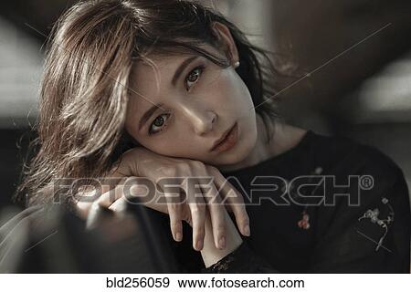 Stock Photo - Caucasian woman leaning on bench. Fotosearch