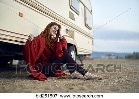 Stock Photo - Caucasian woman leaning on motor home. Fotosearch