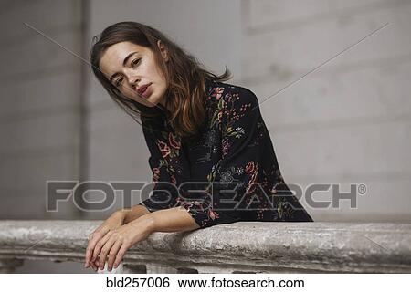 Caucasian woman leaning on railing View Large Photo Image Stock Photograph - Caucasian woman leaning on railing. Fotosearch