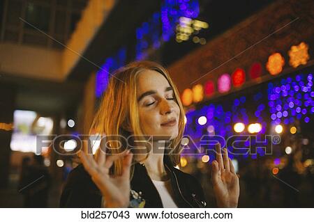 Caucasian woman listening to nightlife View Large Photo Image Stock Image - Caucasian woman listening to nightlife. Fotosearch