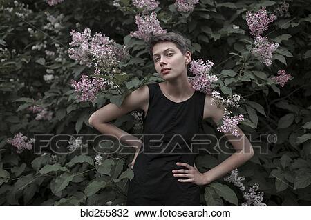 Caucasian woman near flowering tree with hands on hips View Large Photo Image Stock Image - Caucasian woman near flowering tree with hands on hips. Fotosearch