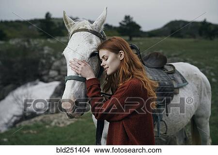 Caucasian woman petting horse View Large Photo Image Picture - Caucasian woman petting horse. Fotosearch