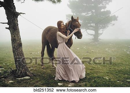 Caucasian woman petting horse View Large Photo Image Stock Image - Caucasian woman petting horse. Fotosearch
