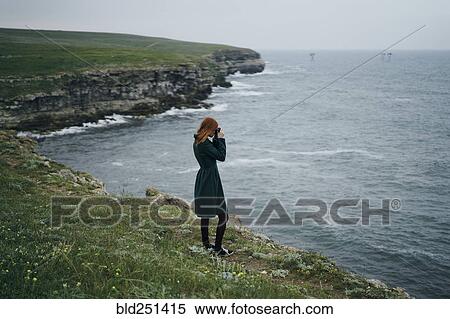 Caucasian woman photographing ocean View Large Photo Image Stock Photography - Caucasian woman photographing ocean. Fotosearch