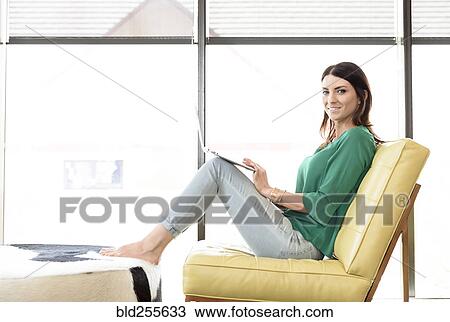 Caucasian woman relaxing and using laptop View Large Photo Image Stock Image - Caucasian woman relaxing and using laptop. Fotosearch