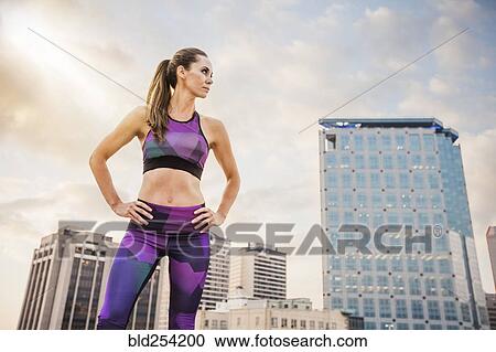 Stock Image - Caucasian woman resting in city. Fotosearch