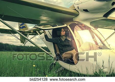 Caucasian woman sitting in airplane cockpit View Large Photo Image Stock Photo - Caucasian woman sitting in airplane cockpit. Fotosearch