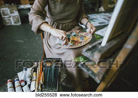 Caucasian woman squeezing paint onto palette View Large Photo Image Stock Photo - Caucasian woman squeezing paint onto palette. Fotosearch