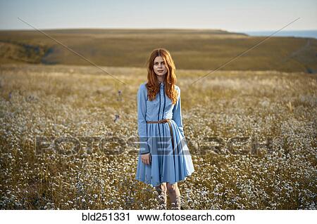 Caucasian woman standing in a field of wildflowers View Large Photo Image Stock Image - Caucasian woman standing in a field of wildflowers. Fotosearch