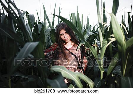 Caucasian woman standing in cornfield View Large Photo Image Stock Photo - Caucasian woman standing in cornfield. Fotosearch