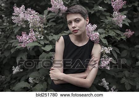 Stock Image - Caucasian woman standing in flowers. Fotosearch