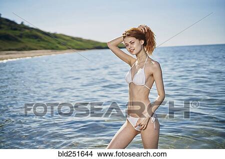 Caucasian woman standing in ocean View Large Photo Image Picture - Caucasian woman standing in ocean. Fotosearch