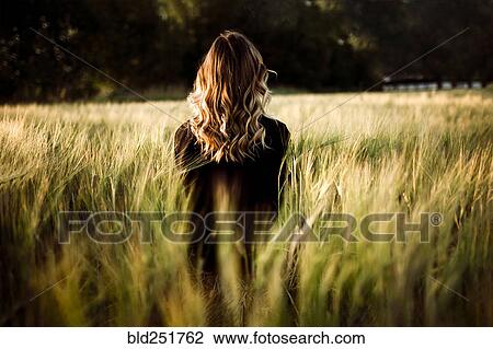 Caucasian woman standing in tall grass View Large Photo Image Stock Image - Caucasian woman standing in tall grass. Fotosearch