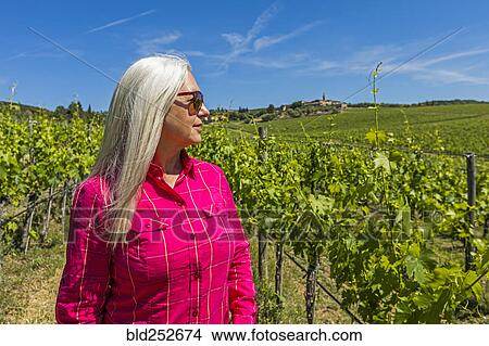 Caucasian woman standing in vineyard View Large Photo Image Picture - Caucasian woman standing in vineyard. Fotosearch