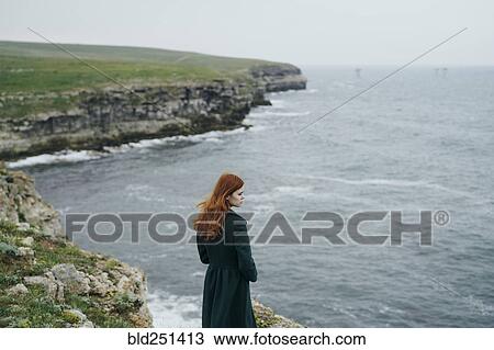 Caucasian woman standing near ocean View Large Photo Image Stock Image - Caucasian woman standing near ocean. Fotosearch