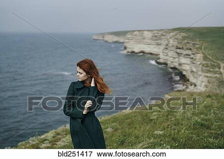 Caucasian woman standing near ocean View Large Photo Image Stock Photo - Caucasian woman standing near ocean. Fotosearch
