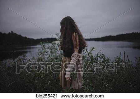 Caucasian woman standing near river View Large Photo Image Stock Image - Caucasian woman standing near river. Fotosearch