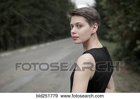Stock Photo - Caucasian woman standing near road. Fotosearch