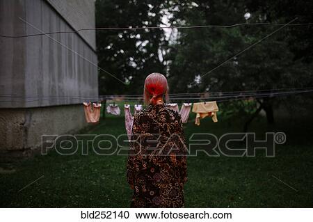 Caucasian woman staring at clothesline View Large Photo Image Stock Image - Caucasian woman staring at clothesline. Fotosearch