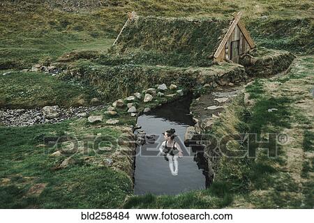 Caucasian woman swimming in pond near rural house View Large Photo Image Picture - Caucasian woman swimming in pond near rural house. Fotosearch