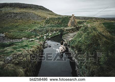 Caucasian woman swimming in pond near rural house View Large Photo Image Stock Photograph - Caucasian woman swimming in pond near rural house. Fotosearch